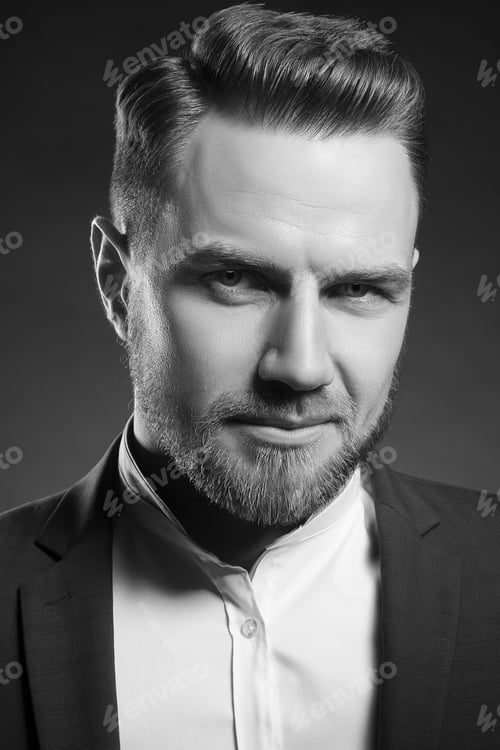 Preview: Handsome Stylish Bearded Young Man In Blue Suit And White Shirt With Perfect Hair Style Looking At