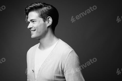 Preview: Studio Shot Of Young Handsome Man Against Gray Background
