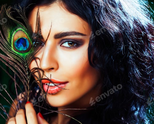 Preview: Young Sensitive Brunette Woman With Peacock Feather Eyes Close Up On Green Smiling, Lifestyle