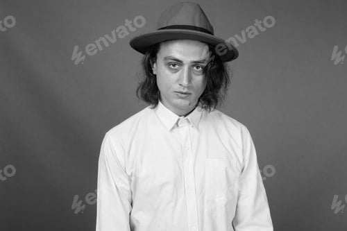 Preview: Portrait Of Young Handsome Man Against Gray Background