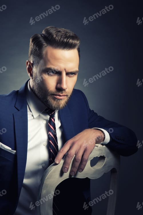 Preview: Young Handsome Bearded Caucasian Man With Blue Eyes Sitting On Chair. Perfect Skin And Hairstyle