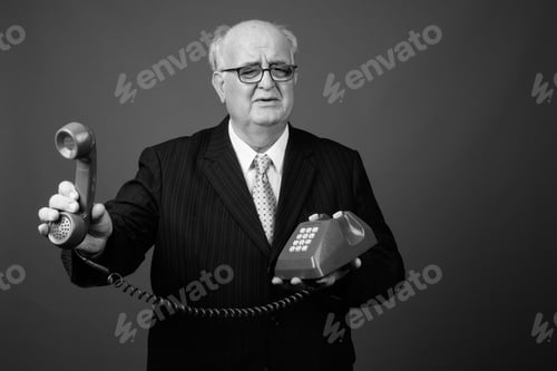 Preview: Overweight Senior Businessman Wearing Eyeglasses Against Brown Background