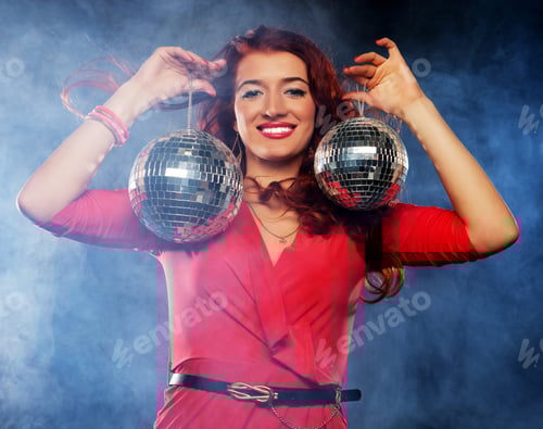 Preview: Beautiful Young Woman Holding Disco Balls At Night Club