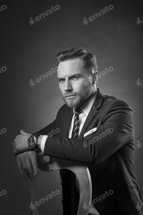 Preview: Young Handsome Bearded Caucasian Man With Blue Eyes Sitting On Chair. Perfect Skin And Hairstyle