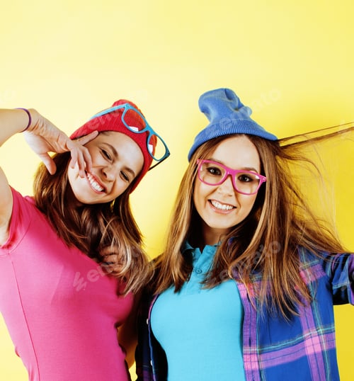 Preview: Lifestyle People Concept: Two Pretty Young School Teenage Girls Having Fun Happy Smiling On Yellow