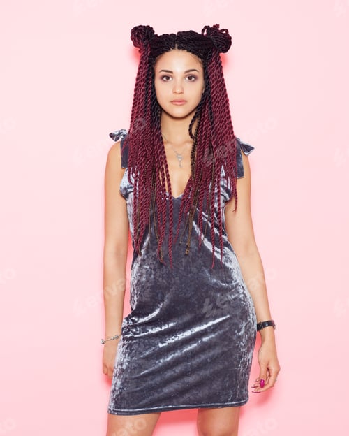 Preview: A Beautiful Girl With African Braids Posing, Looking At The Camera In A Silvery Trendy Dress