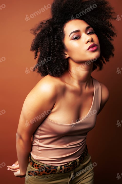 Preview: Pretty Young African American Woman With Curly Hair Posing Cheerful Gesturing On Brown Background