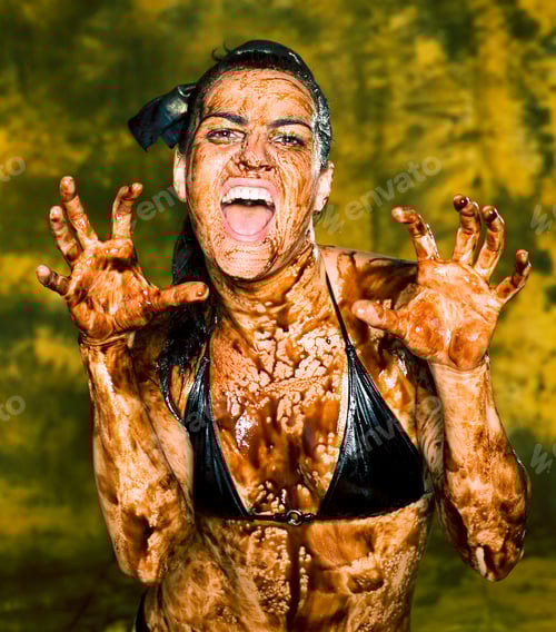 Preview: Young Brunette Girl On Bright Background Covered Chocolate Cream All Over Her Body And Face