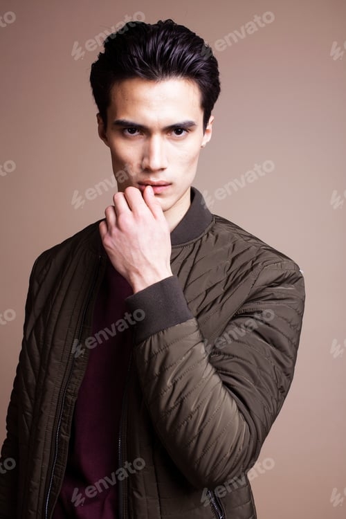 Preview: Young Pretty Asian Man Posing In Fashion Style On Light Brown Background, Lifestyle People Concept