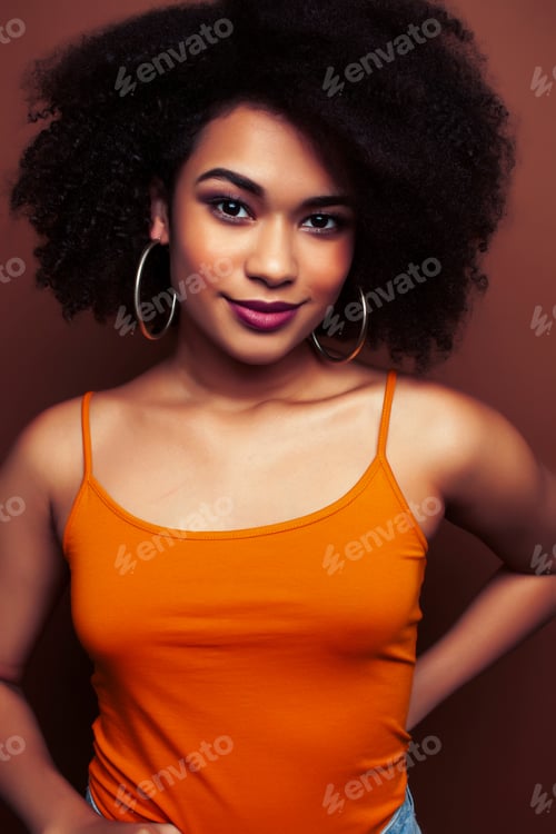 Preview: Pretty Young African American Woman With Curly Hair Posing Cheerful Gesturing On Brown Background