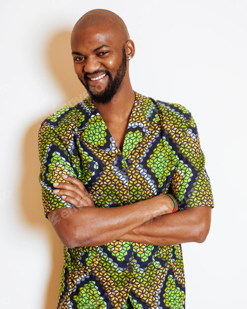 Preview: Portrait Of Young Handsome African Man Wearing Bright Green National Costume Smiling Gesturing