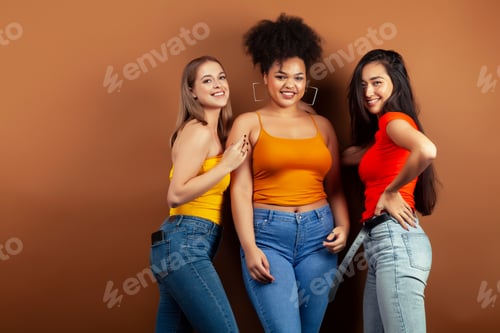 Preview: Young Pretty Multiracial Girls Posing Cheerful On Brown Background, Lifestyle People Concept