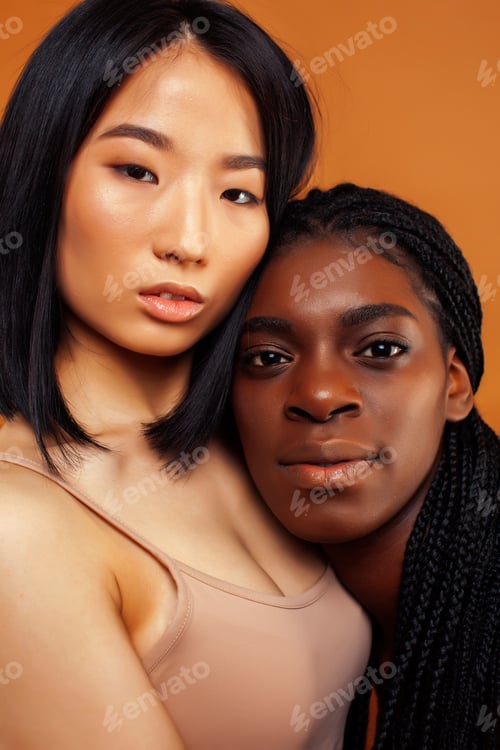 Preview: Young Pretty Asian, Afro Woman Posing Cheerful Together On Brown Background, Lifestyle Diverse