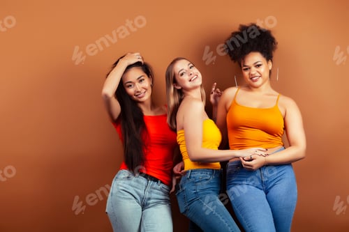 Preview: Young Pretty Multiracial Girls Posing Cheerful On Brown Background, Lifestyle People Concept