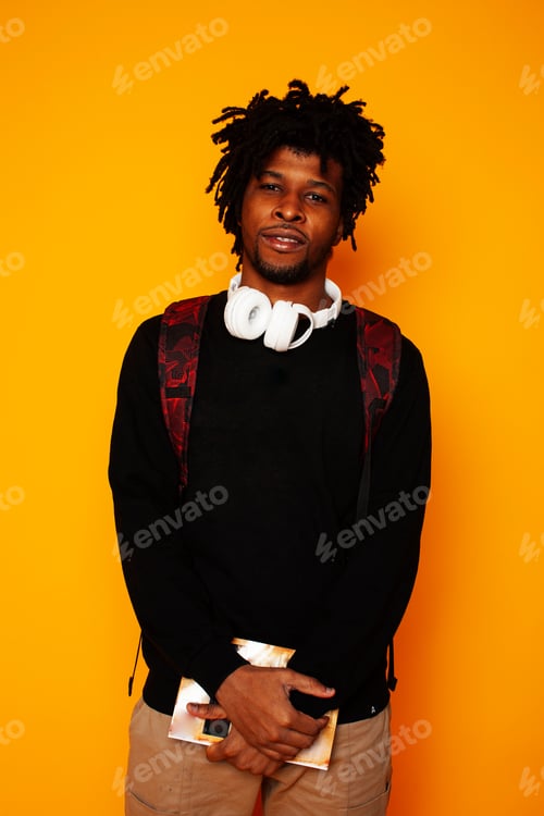 Preview: Young Handsome African American Guy Student Posing Cheerful And Gesturing On Yellow Background