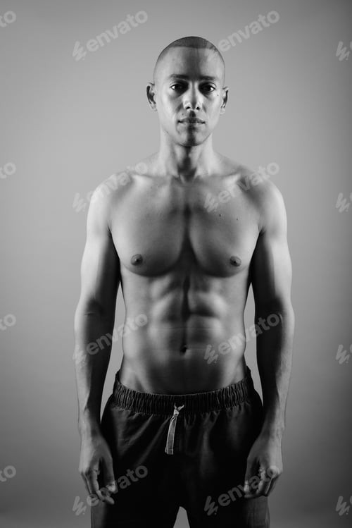 Preview: Handsome Bald Man Shirtless Against Gray Background