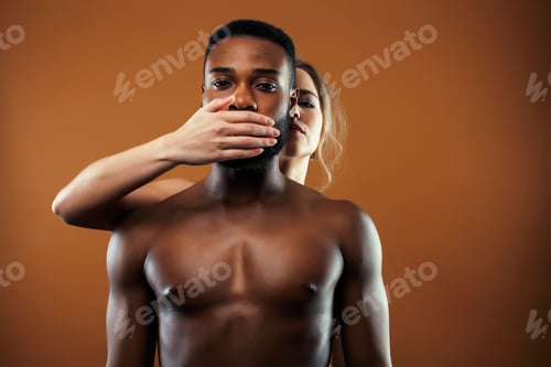 Preview: Young Pretty Couple Diverse Races Together Posing Sensitive On Brown Background, Lifestyle People