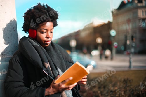 Preview: Afro Woman Reading A Book On The Street.