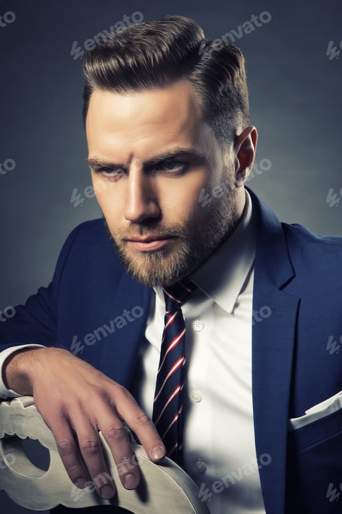 Preview: Young Handsome Bearded Caucasian Man With Blue Eyes Sitting On Chair. Perfect Skin And Hairstyle