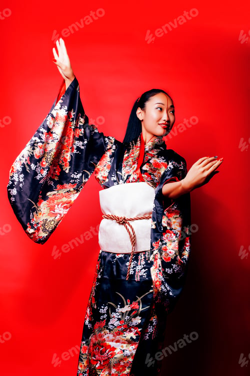 Preview: Young Pretty Geisha On Red Background Posing In Kimono, Oriental People Concept Close Up