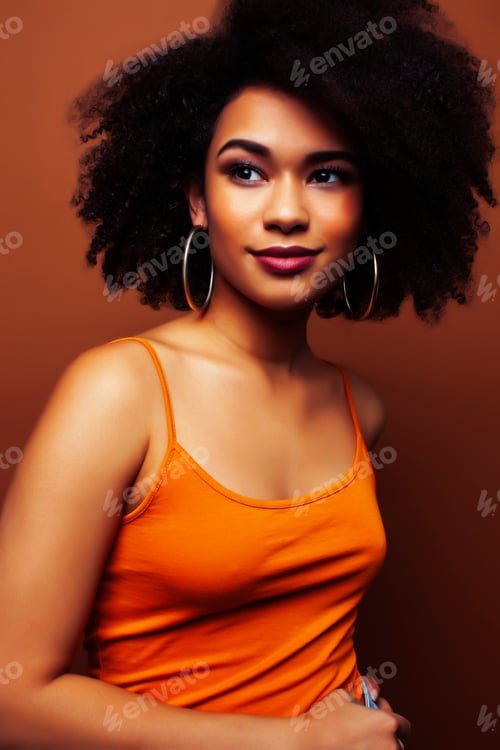 Preview: Pretty Young African American Woman With Curly Hair Posing Cheerful Gesturing On Brown Background