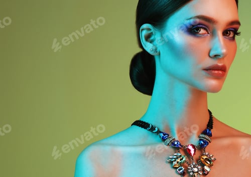 Preview: Beautiful Fashion Model Wearing Elegant Jewelry In Color Light, Fashion Beauty Concept