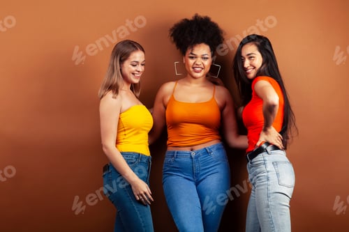 Preview: Young Pretty Multiracial Girls Posing Cheerful On Brown Background, Lifestyle People Concept