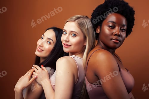 Preview: Young Pretty Asian, Caucasian, Afro Woman Posing Cheerful Together On Brown Background, Lifestyle