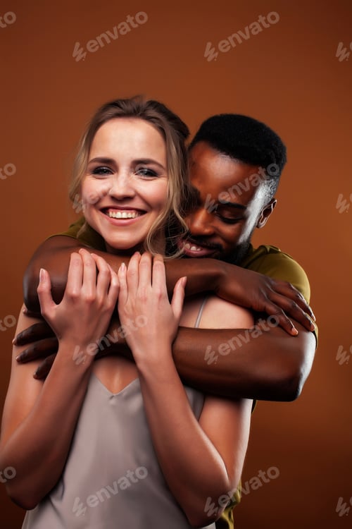 Preview: Oung Pretty Couple Diverse Races Together Posing Sensitive On Brown Background, Lifestyle People