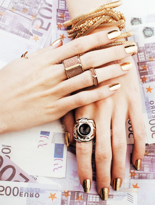 Preview: Hands Of Rich Woman With Golden Manicure And Many Jewelry Rings