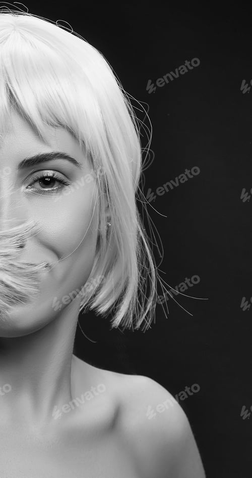 Preview: Smiling Beautiful Caucasian Woman Wearing Colorful Short Hair Wig Isolated On Black Background