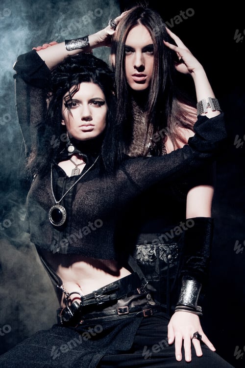 Preview: Romantic Portrait Of Young Gothic Couple - Man And Woman Over Dark Background.