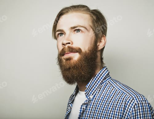 Preview: Stylish Bearded Man In Shirt. Close Up Portrait Over Grey Background.
