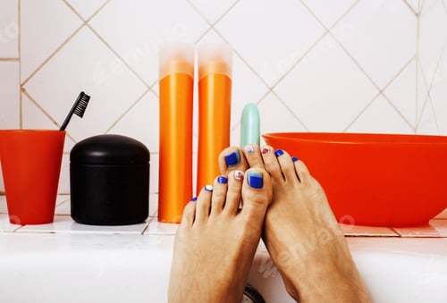 Preview: Woman Legs In Bathroom With Lot Of Stylish Stuff For Care, Pedic