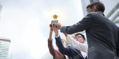 Preview: Group Of Business People Giving Away Trophies To Confirm The Success Of The Increased Sales On