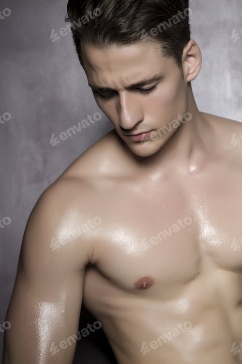 Preview: Sexy Shirtless Male Model Flirting Against Of Grunge Wall.