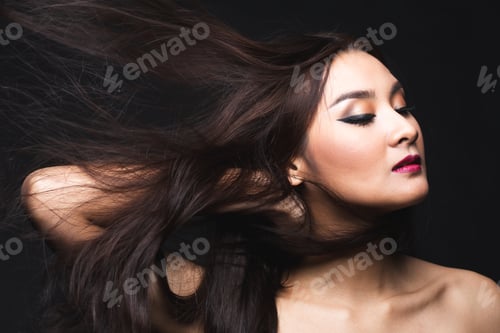 Preview: Portrait Of Young Asian Woman With Makeup Long Hair On The Black Isolated Posing.