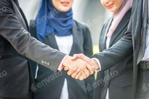Preview: Welcome Onboard! Muslim Asian Business People Shaking Hands With New Partner, Business Co-Working