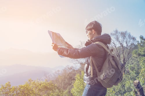 Preview: Young Man Traveler With Backpack Relaxing Outdoor With Rocky Mou