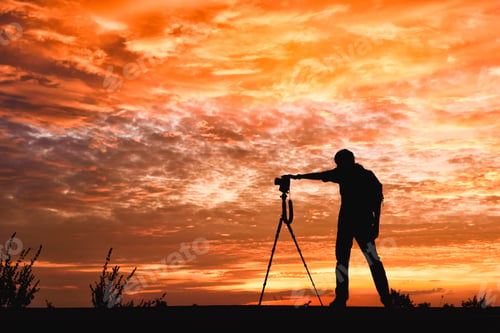 Preview: Silhouette Image Of A Photographer With A Sunset Background .
