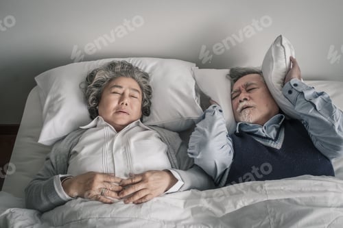 Preview: Elderly Couple Caucasian Senior Man And Woman Sleep On Bed And Snoring In White Blanket In Bedroom