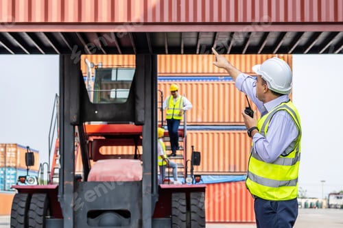 Preview: Young Male Engineer Or Manager Use Of Radio Communication To Control Container Load In Industrial