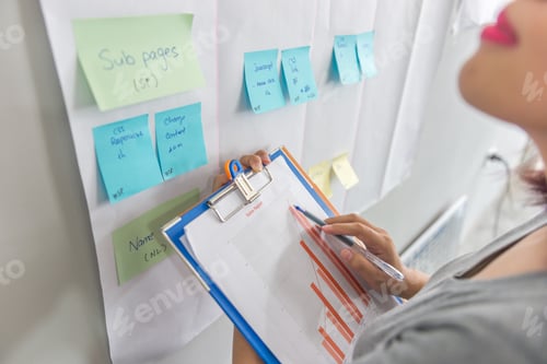 Preview: Close-Up Woman Hands Holding And Pointing At Sales Chart Document