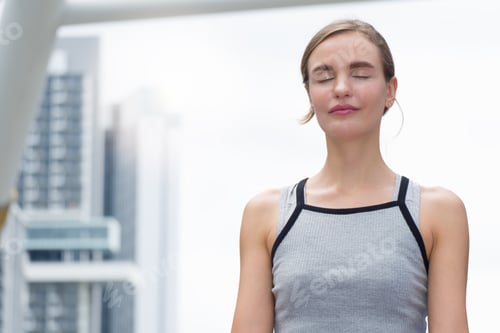 Preview: Caucasian Woman Is Doing Yoga Exercise Outdoors In A Modern City Surrounded By Tall Buildings