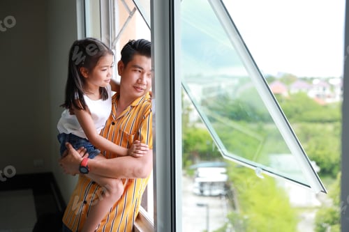 Preview: Happy Asian Young Single Dad Holding His Daughter With Happy Smiling Face And Looking Away Through