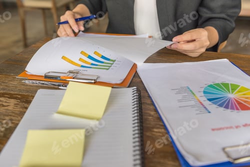 Preview: Young Businesswoman Hand Reading Many Report About Sales