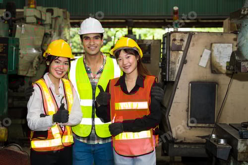 Preview: Group Of A Multi-Ethnic Factory Worker, Are Standing And With A Thumbs Up In Front Of Their