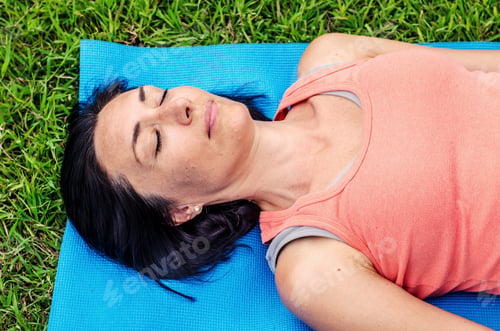 Preview: Happy Woman Wearing Casual Clothes Lying On The Ground In The Green Park