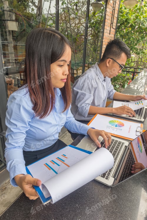 Preview: Business Team Working On Laptop And Sales Report