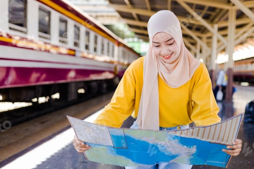 Preview: Muslim Woman Is Looking At Maps To Plan Their Travel Plans.